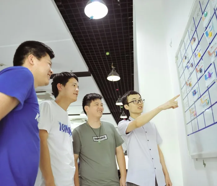 Team discussing sticky notes at a whiteboard