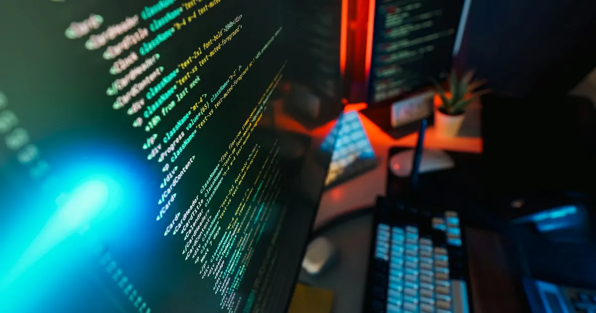 Programming workspace with illuminated computer screens