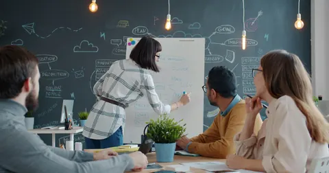 Colleagues sharing ideas at a whiteboard