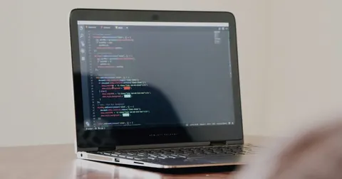 Laptop displaying programming code