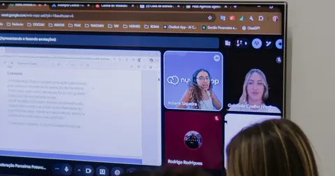People joining a video conference on a large screen