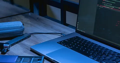 Laptop and phone at a programming workspace
