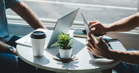 Colleagues working with laptops at a table